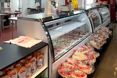 Inside Abdu Market: the halal meat display case stocked with fresh cuts